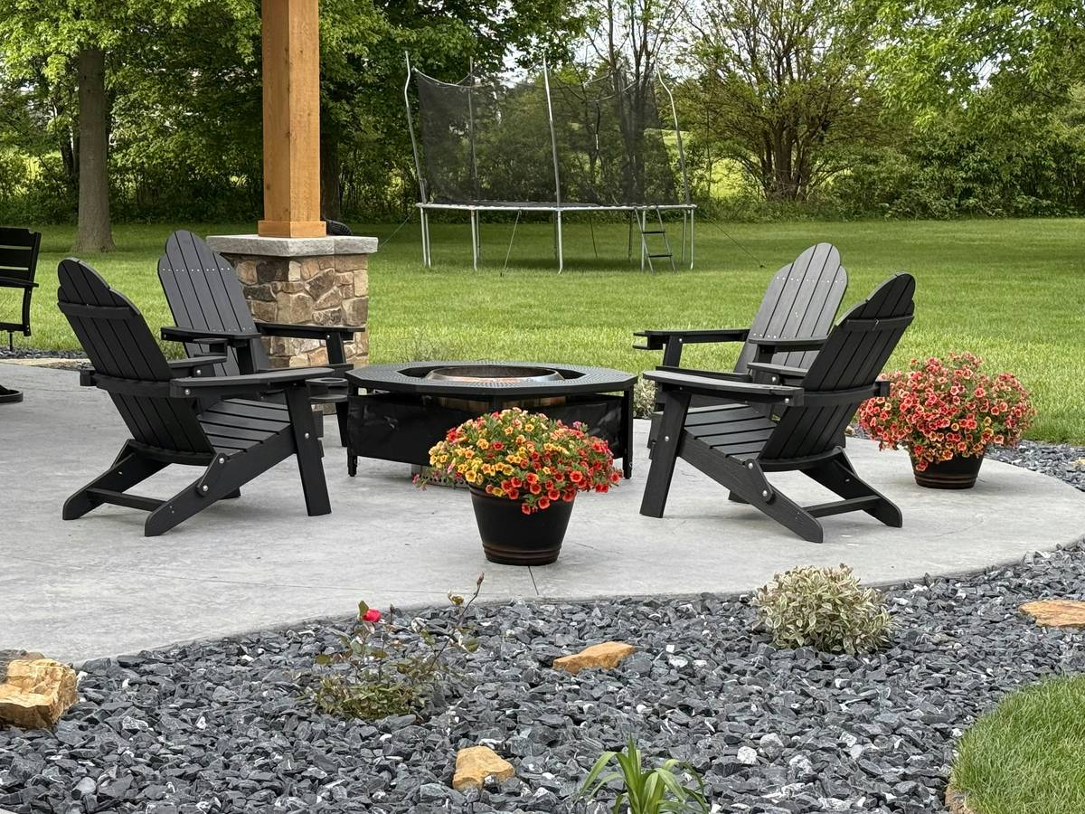 how to garden with weather-resistant stone and metal statues in a sunlit backyard